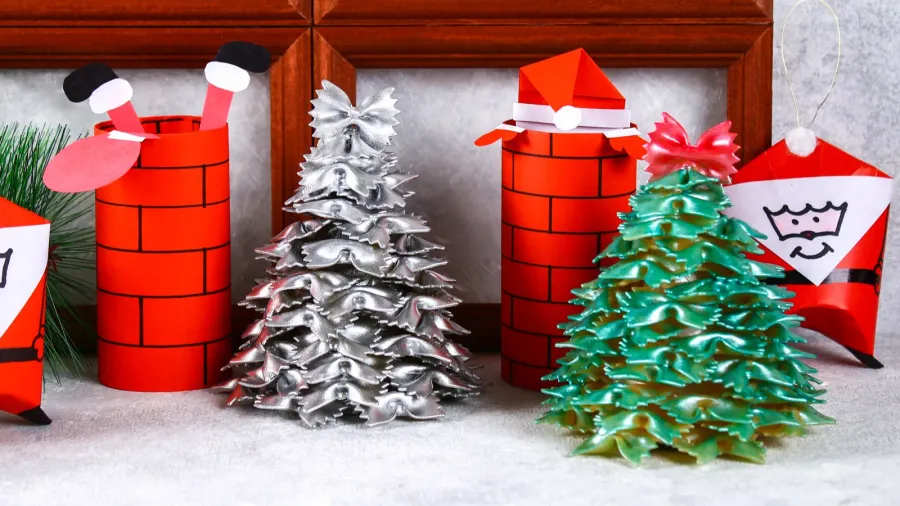 Christmas Santa Claus in chimney made from toilet paper hub, colored paper, marker, glue, fishing line and cotton pad. DIY toy on the Christmas tree. Handmade Guide, step by step. Christmas decor
