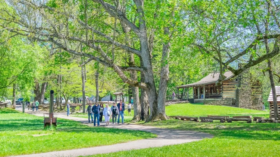 Cades Cove, Tennessee, United States – April 24, 2023: Horizontal shot of Cades Cove visitors in the Great Smoky Mountains National Park. Cades Cove Visitors Center to the right.