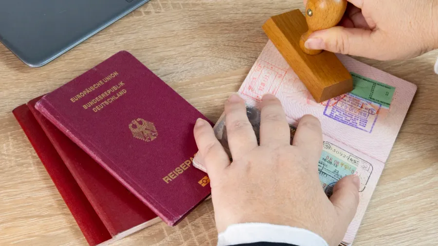 closeup of female border patrol officers meticulously inspecting foreign passports