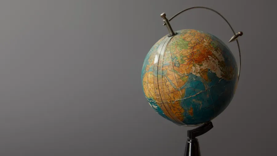 old globe on dark textured surface on grey